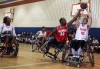 Wheelchair basketball players exhibit their skill for youngsters