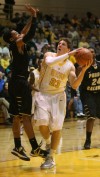 Purdue Calumet's Warren Gordon tries to block a shot by Valparaiso University's Matt Kenney