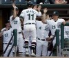 060711BBMRAILCATS, RailCats Mike Valadez gets all high-fives from the dugout