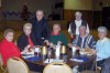 Clergy serve wine at feast day dinner