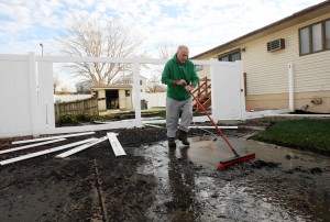 : Joe Brown cleans up flood damaged to his home on Glenwood Ave in West Wildwood. Residents of Cape May County deal with the clean-up in the wake of Hurricane Sandy. Wednesday Oct. 31, 2012. (Dale Gerhard/Press of Atlantic City)
 - Photo by Dale Gerhard