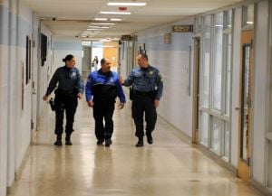 Increasing Patrols: Hamilton Township Police officer, Nicole Nelson, of Mays Landing, Oakcrest High School security officer, Robert Maldonado, of Galloway Township, and Hamilton Township Police Sgt. Greg Ciambrone, of Mays Landing, walk through the halls of Oakcrest High School at various times during the school day. Hamilton officer at Oakcrest High School, in Mays Landing. In the wake of last months Newtown, Conn. school massacre the township has stepped up patrols and is working with schools and other public facilities to ensure safety. Thursday, January, 17, 2013( Press of Atlantic City/ Danny Drake)
 - Photo by Danny Drake