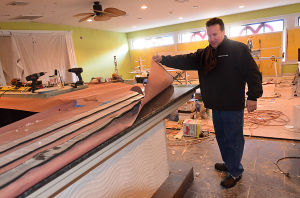 Tale Of Two Restaurants: Johnny Liccio checks the granite top of the new central bar inside the under-construction area beside the original Johnny's Cafe. Johnny's Cafe in Margate is expanding in both directions while neighboring restaurant Fedeli's, a staple in town for decades, is permanently closed.
 - Photo by Ben Fogletto