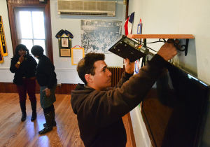 Mac Exhibit: Maintenance assistant Josh Pfaff of North Cape May sets up a slideshow Friday for the exhibit opening on Martin Luther King Day at the Carriage House at the Emlen Physick Estate.
 - Photo by Ben Fogletto