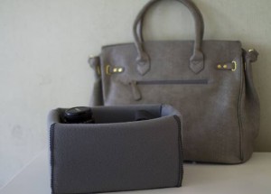 Handmade insert hides bulky camera in purse