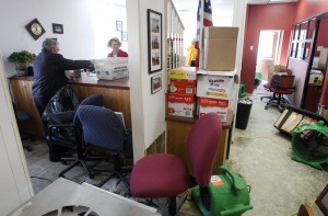  : Sea Isle City postmaster Steve Hickey (left) delivers the mail to city tax collector Paula Doll in the damaged city hall. Sea Isle City city hall was flooded for the first time since 1962. Residents of Cape May County deal with the clean-up in the wake of Hurricane Sandy. Wednesday Oct. 31, 2012. (Dale Gerhard/Press of Atlantic City)
 - Photo by Dale Gerhard