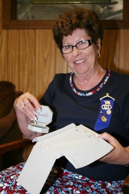 Lou Marshall displays the pearl necklace and earrings she received as a 