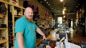 Kevin Begola, 35, owner of Bridge Street Exchange at 109 North Bridge St., stands in his men’s specialty store. He had the idea to design and sell wedding bands when he was 23.