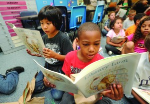 <p>Juan Montanez Jr., left, and Myalek Woods look at the new book, “Library Lion,” they received Tuesday as part of the Janice’s Storybook Summer program through Brazosport ISD.</p>
