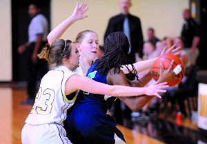 <p>Danbury's Brittany Brooks (23) and Abbie Box pressure a Yes Prep
Southwest's Lashawn Coleman during the second quarter of the girls
varsity basketball game Friday at Danbury High School.</p>
