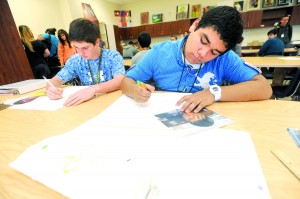 <p>Marcello Diaz, right, and Jason Peltier work on self-portraits
Thursday during class at Angleton High School. Both students have
artwork that will be on display for the Houston Livestock Show and
Rodeo art show.</p>
