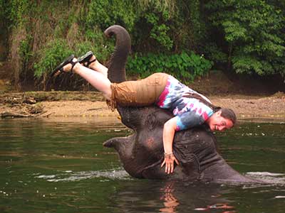CRYSTAL STEINMUELLER is pictured here with 5-year-old Johnny, who was rescued from begging on the streets, at Elephants World, Kanchanaburi, Thailand. Steinmueller has traveled to more than 33 countries.