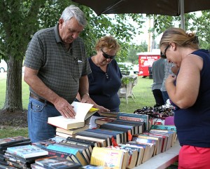 <p>(Clockwise from top) Don and Charlsie Crowder look at some books Vicky Shores has for sale Friday at one of the stops on 67th Stree in Fort Payne along the U.S. 11 Antique Alley yard sale.</p>
