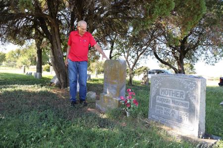 Robert Nussman, vice president of the East Waco Greenwood Cemetery Association, stands near the headstones of his German immigrant grandfather, Herman Nussman, and grandmother, Augusta Nussman. Robert Nussman photo