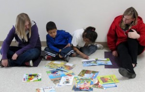 Haley Aust (left) and Harley Bailey work with kindergarten students.