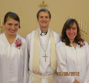 Confirmands (from left) are Cara Schmidtke, Pastior Mike Bitz and Kristina Harder.