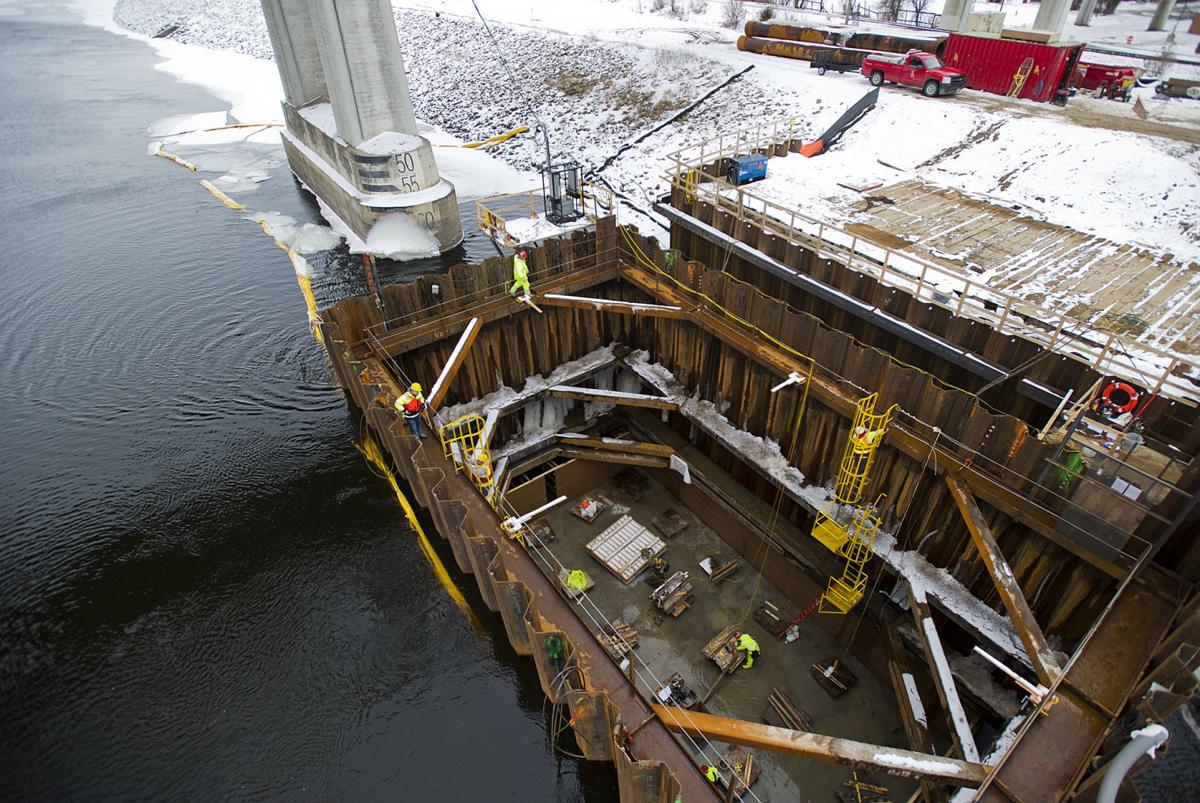 Working at the river's bottom Crews stay dry in cofferdam as pier work continues in the