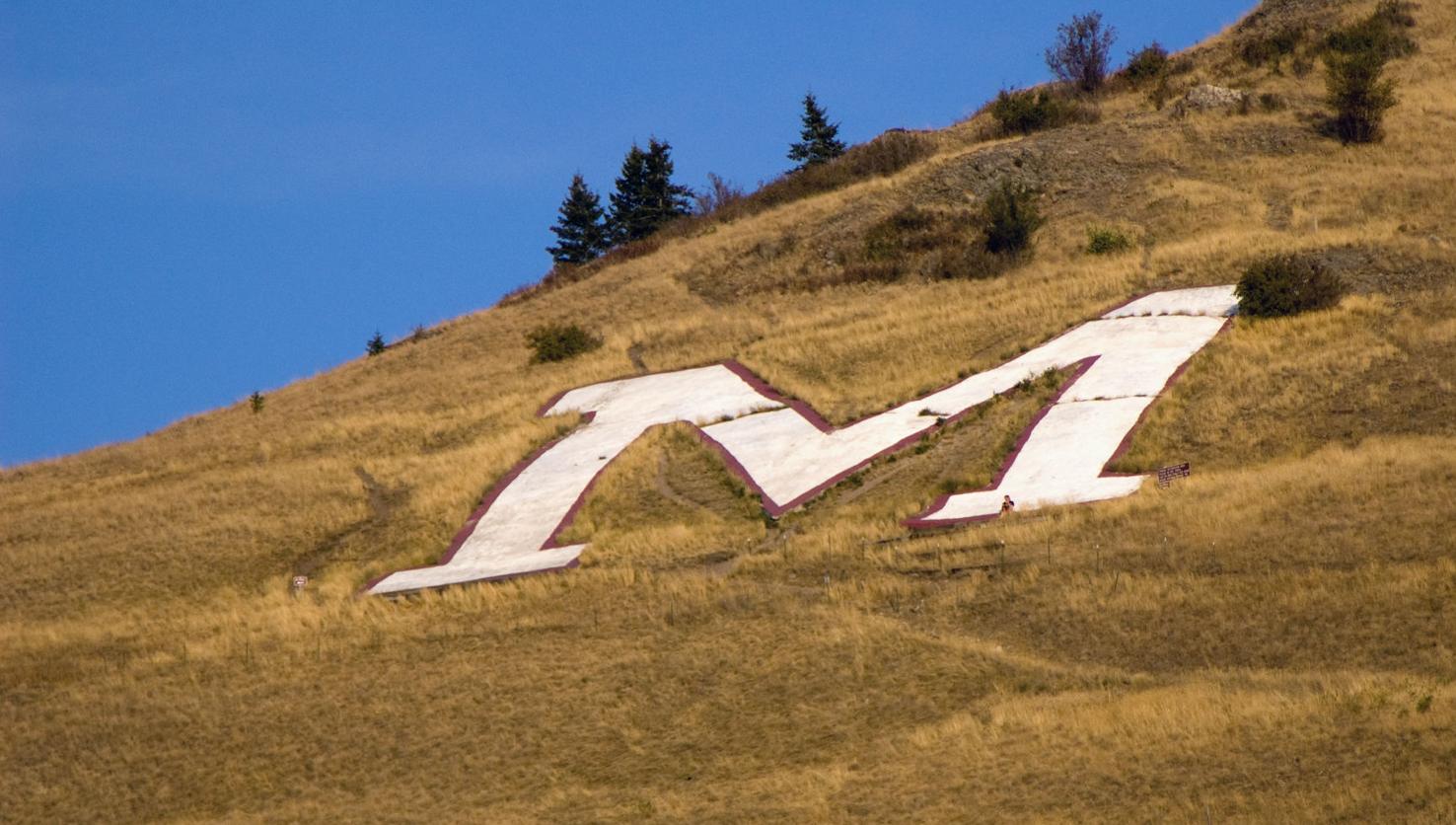 Hillside letters, symbols of town and school pride, are stamped on the