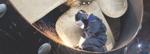 A welder makes a repair to a ship's propeller.