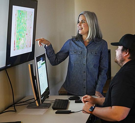 Katy Rainey and Vincent Seal view imagery of soybean trials