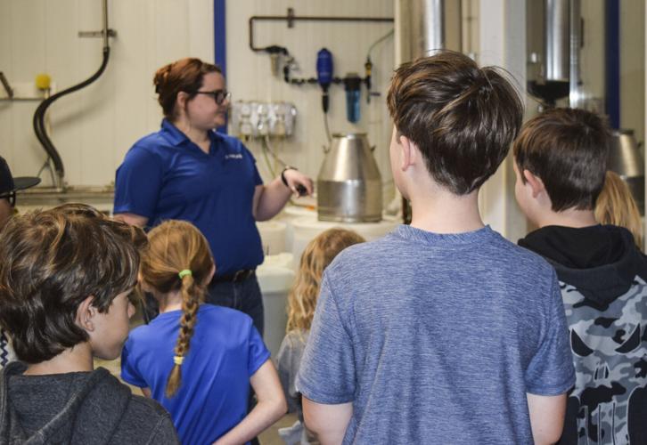 Laura Grey talking to kids about robotic milker