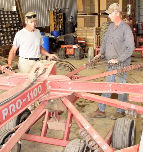 Brian Igl and Brad Igl check rake