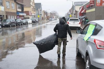 Members of Community Cleanup MKE don rain gear to pick up trash on S 13th Street on the afternoon of March 15, 2026 in Milwaukee, Wisconsin.
