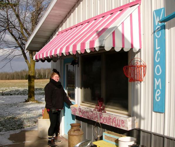 Lynn Hicks in front of shop