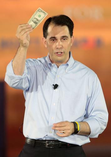 Scott Wallker waves dollar