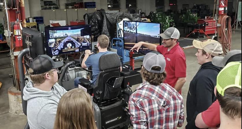 FISC students watching tractor simulator