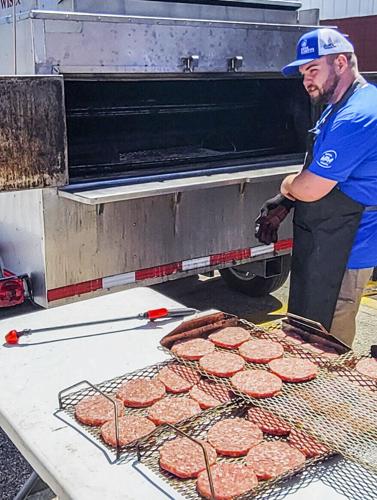 Joshua Heerts with pork cooker