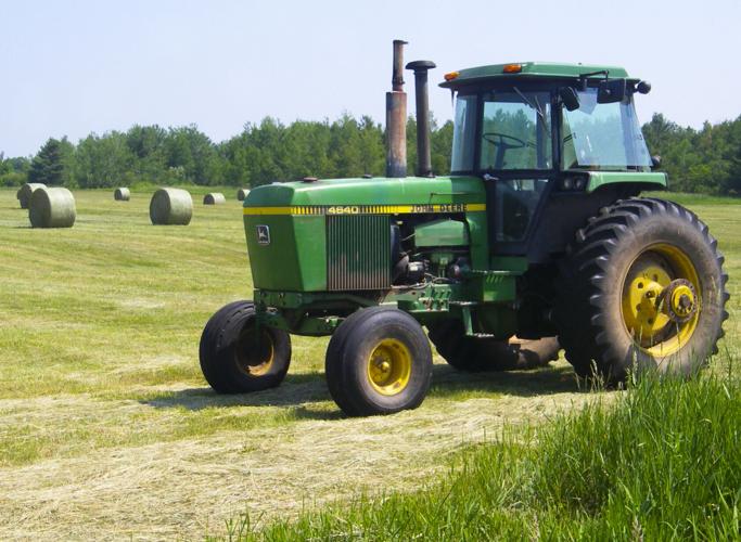 Tractor near baled hay