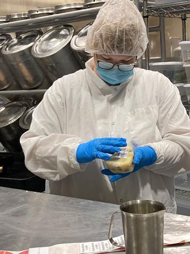 ISU Creamery student worker makes cheese curds