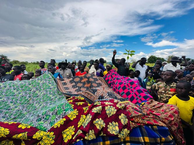 Brightly colored fabrics are part of well dedication.jpg