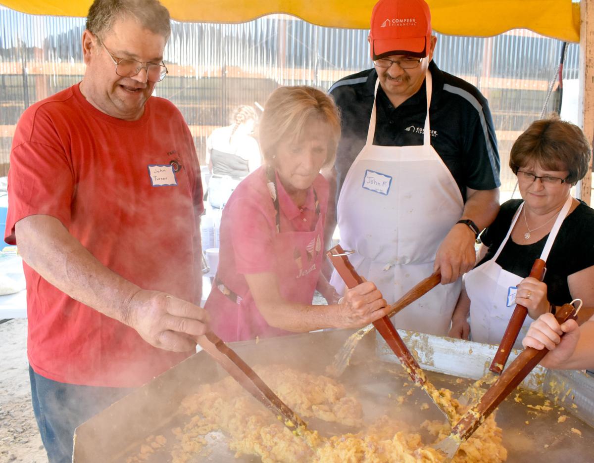 Volunteers cook a mountain of eggs