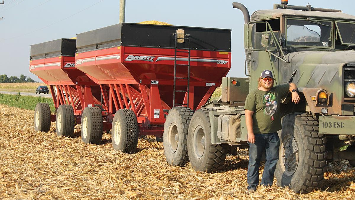 Levi Isham waits at the end of the field with wagons