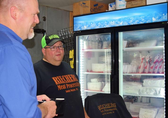 Randy Romanski and Mike Riechers with meat cooler