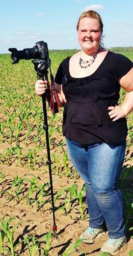 Amanda Borkowski holds camera in field
