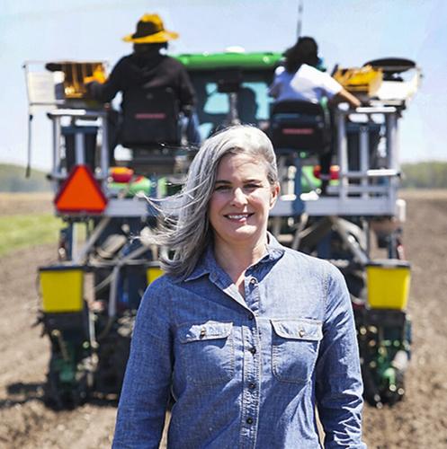 Katy Rainey in field with planter