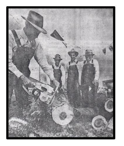 A show visitor in 1960 operates a chainsaw while his three brothers observe.