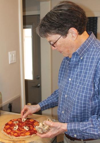 Helen Gunderson prepares a pizza