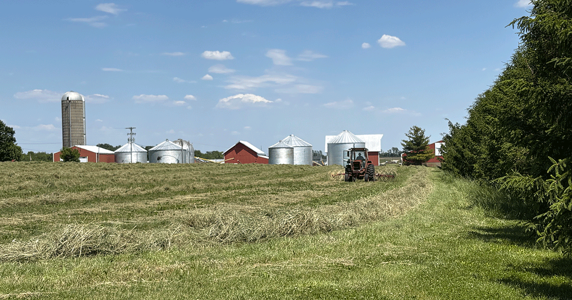 hay baling with tractor in field