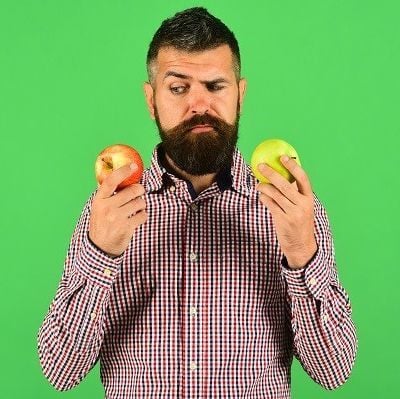 Man looks at fruit apples