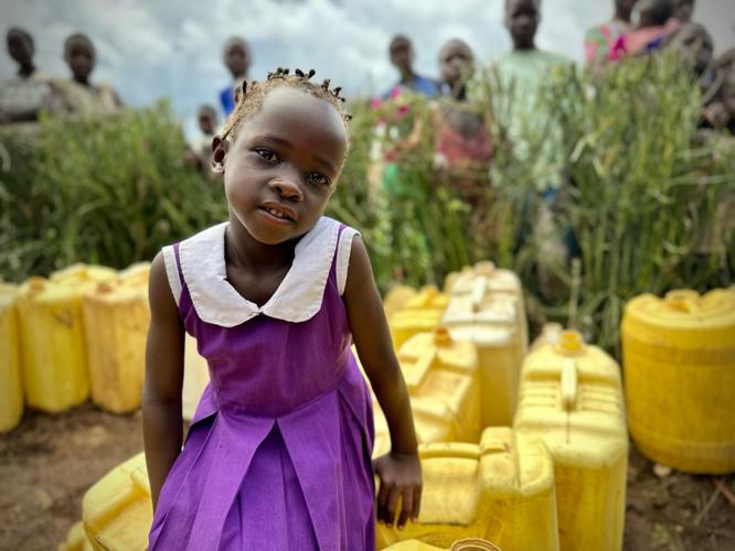 Girl with jerry cans.jpg