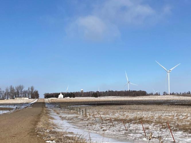 Winter rural church and wind turbine