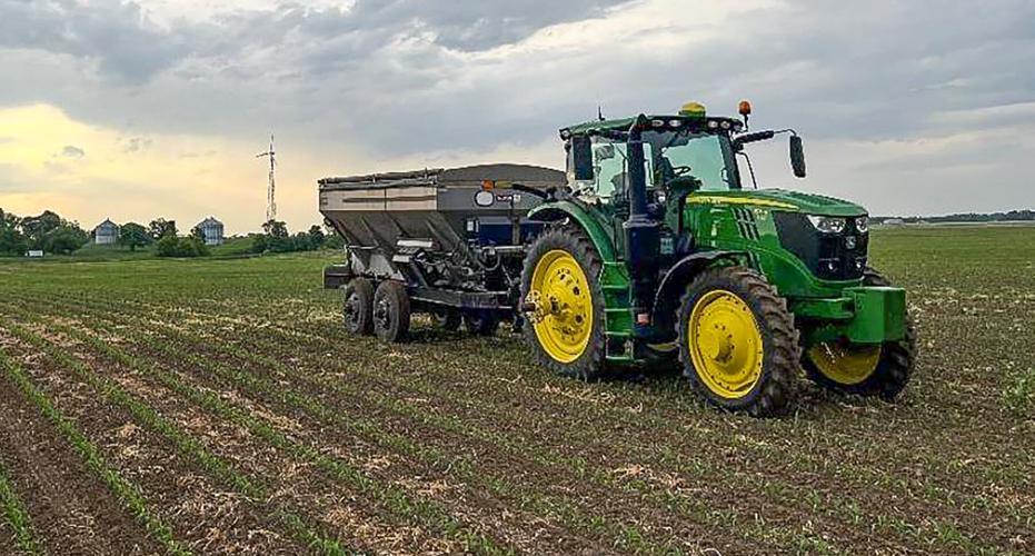 Tractor and manure spreader in field