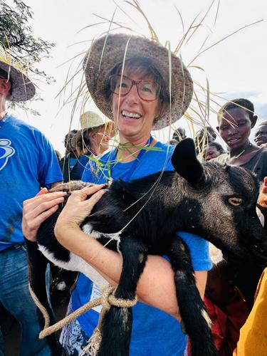 Pastor Leah Krotz with well dedication gift of a goat.jpg
