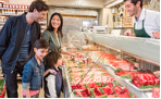 family at beef counter