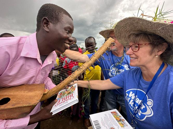 Pastor Leah presenting Bible to Ugandan youth.jpg