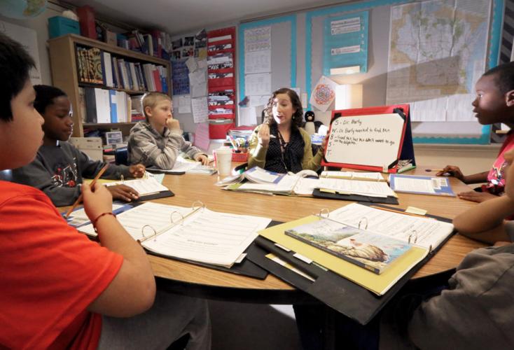 Meg Healy works on reading with students